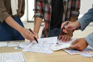 A team of multifamily developers brainstorming after analyzing multifamily data.